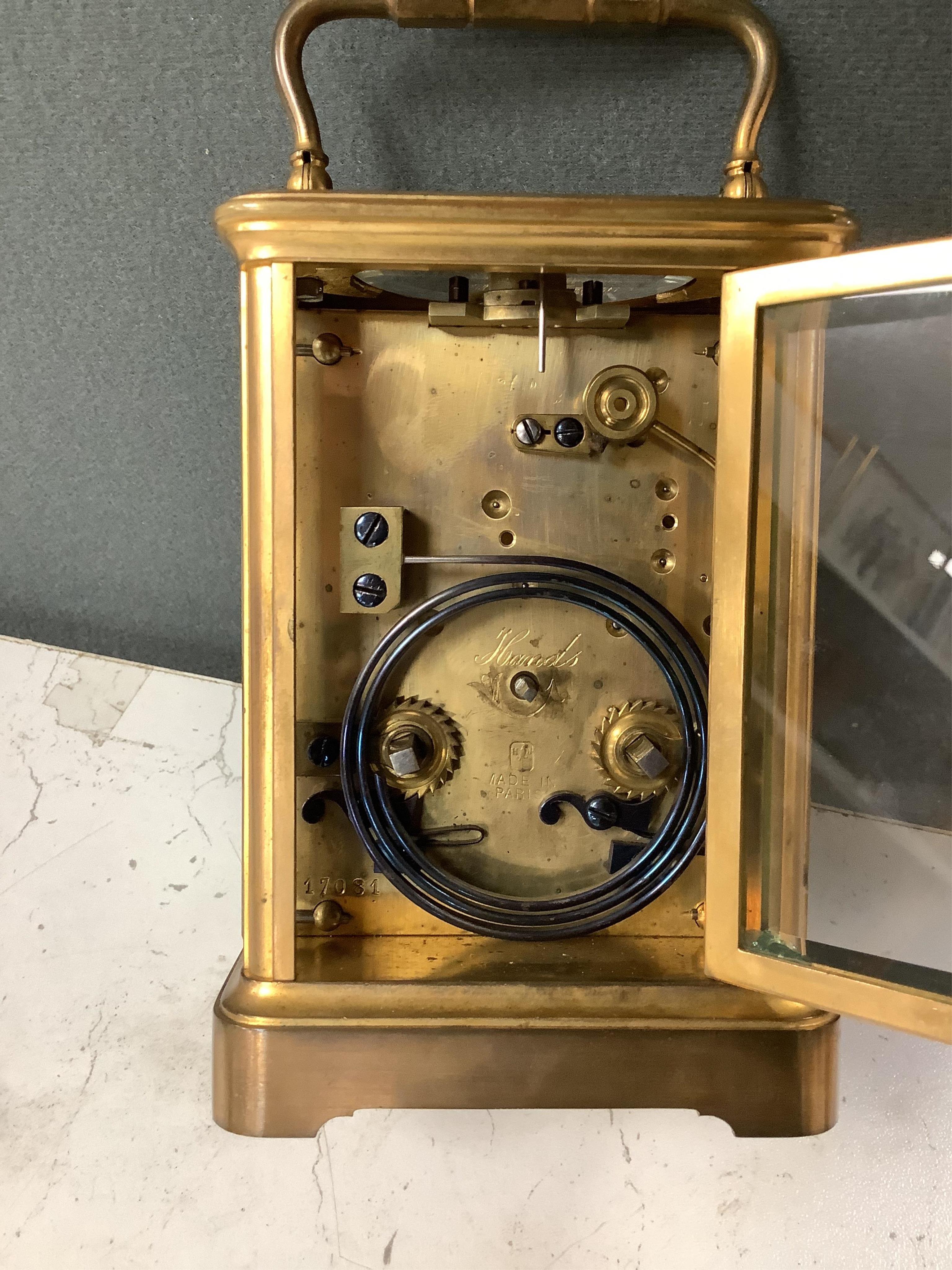 A late 19th century lacquered brass repeating carriage clock, by Henri Jacot and an Edwardian inlaid mantel timepiece with key, largest 23cm high